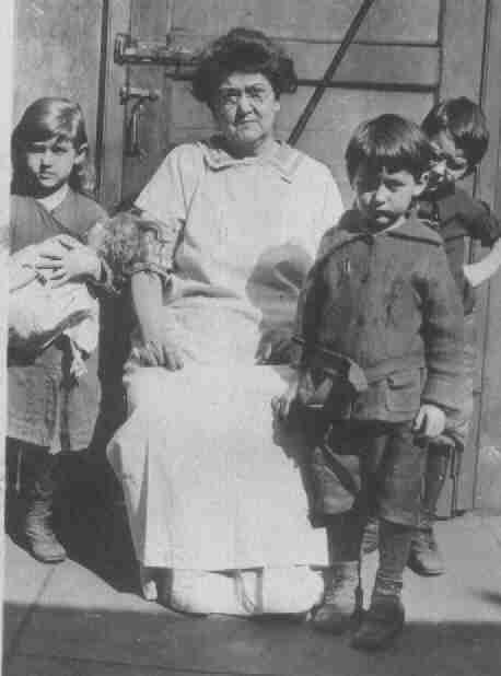 Mary Paul, older woman in center. On left, Marie, center is John, on right is Christopher 1921